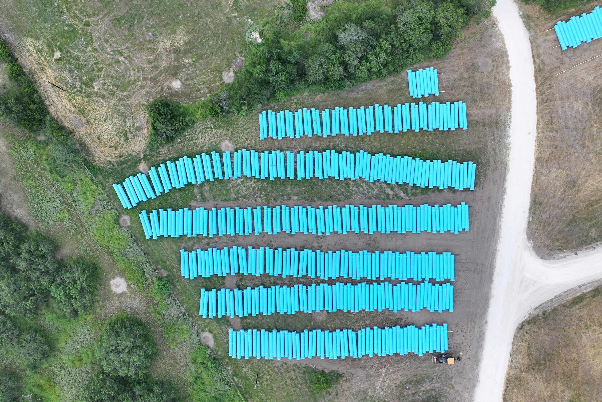 Rows of pipe line an open field in the City of Corpus Christi's Western Ground Water Well Field Monday, July 13, 2026.