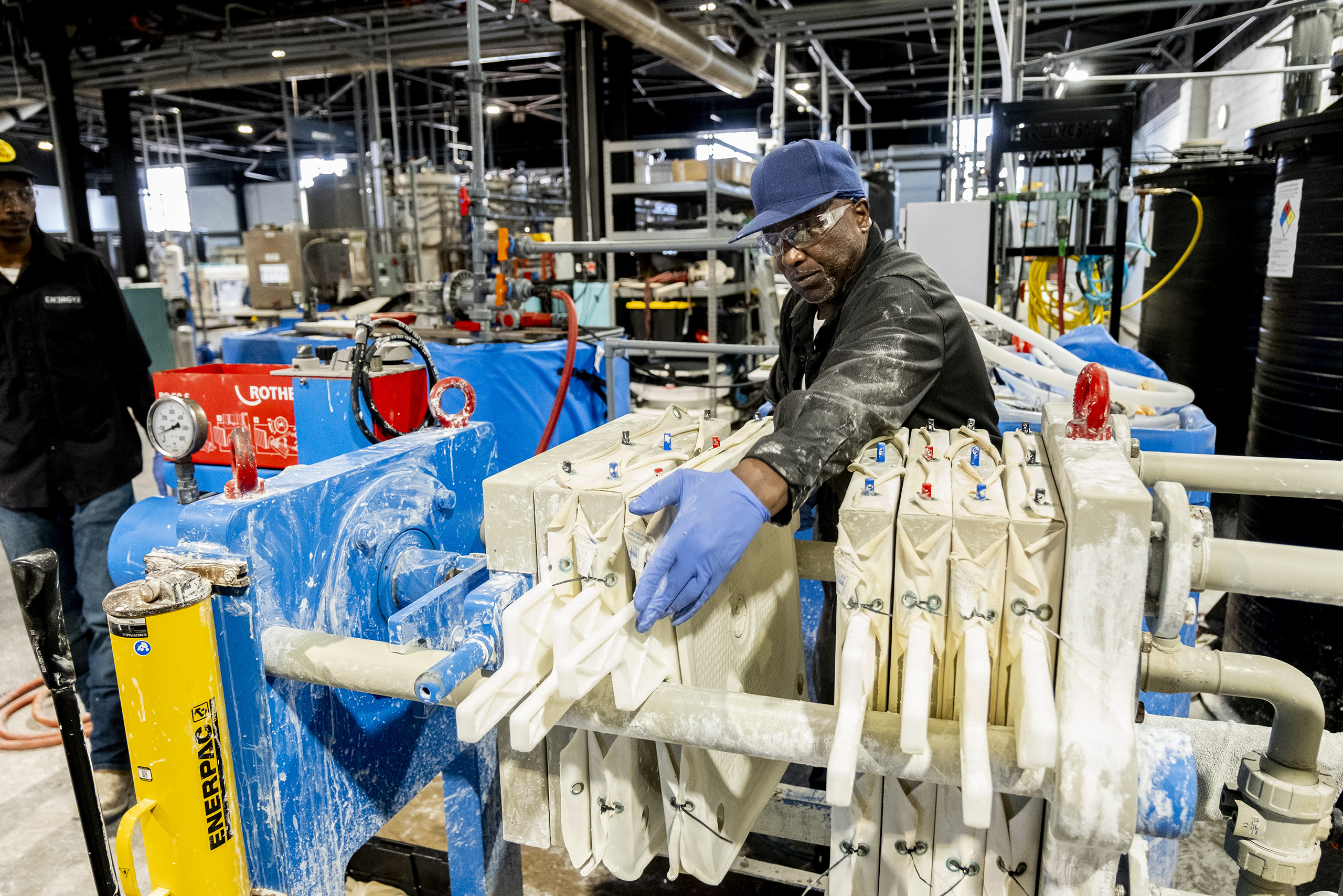 EnergyX's Marvin Simmons cleans out a filter during the direct lithium extract process.