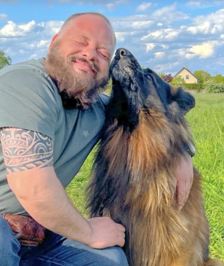 Matt embraces Barry, his long-haired German shepherd.